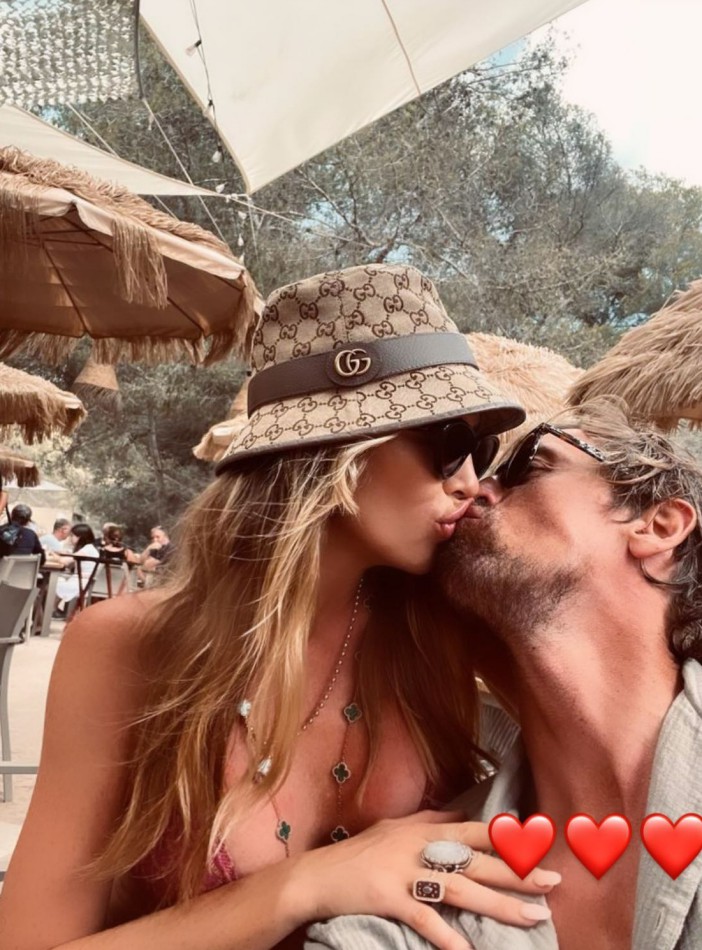Abbey Clancy and husband Peter Crouch enjoy passionate kiss as they cosy up on family holiday
