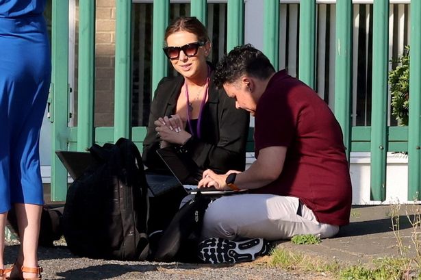 Teachers seen crouching with laptops as school evacuated over crumbling concrete crisis