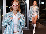 Rita Ora puts on a risqué display in white pants underneath a blue tartan coat as she steps out in NYC ahead of the Met Gala
