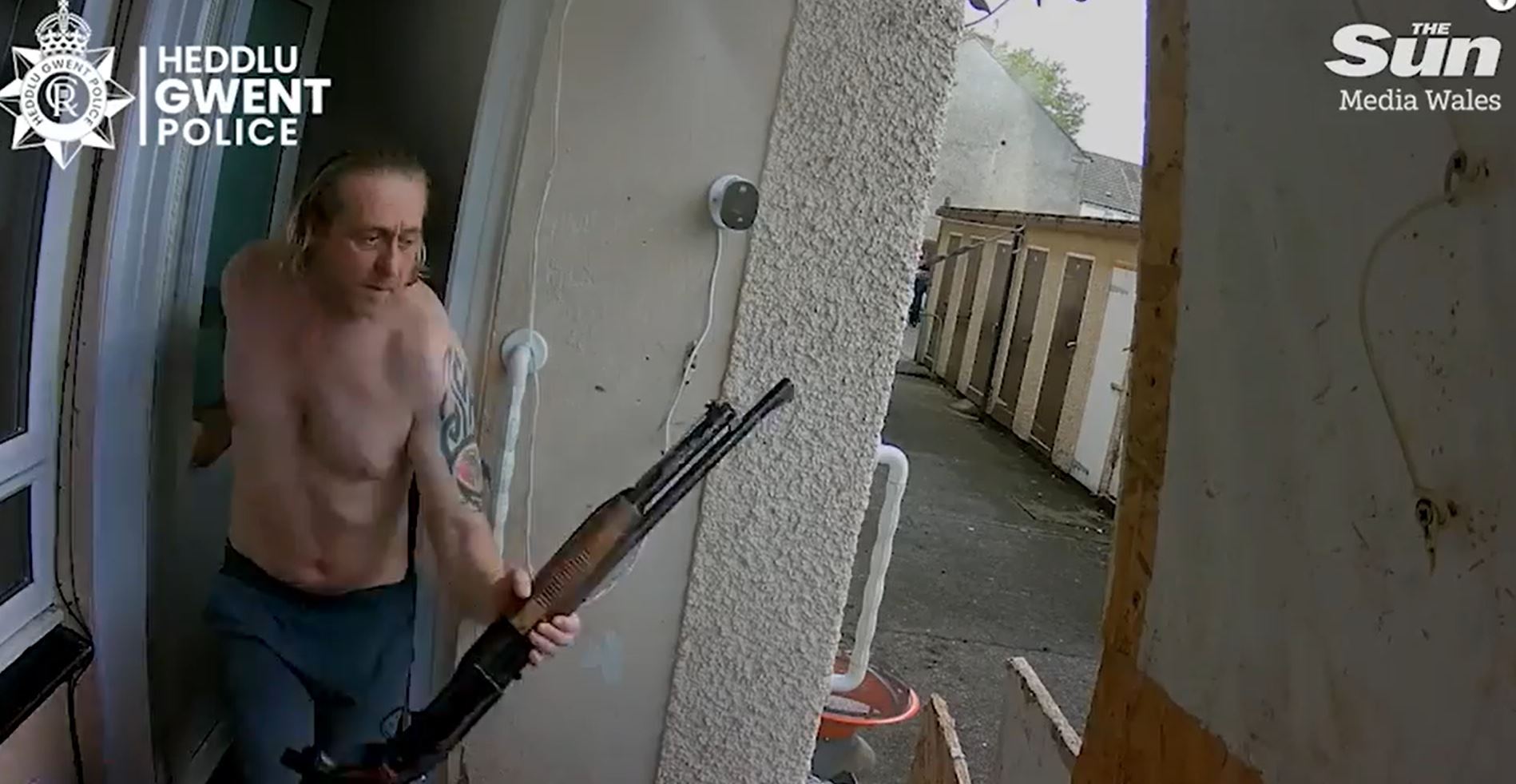Shocking moment shirtless man charges his neighbour with SHOTGUN in row over ‘loud music’ before he’s cornered by cops