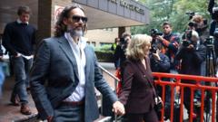 Russell Brand appears in court for start of rape trial