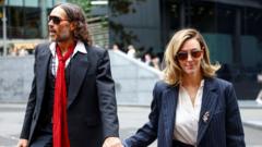 Russell Brand’s wife tells his rape trial he is ‘kind and a wonderful father’